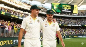 Australian cricketers Scott Boland and Brendan Doggett walk side-by-side on a stadium field, wearing baggy green caps and white Test uniforms. Boland has his arm around Doggett's shoulder, and both are smiling. The background shows a cheering crowd and a scoreboard reading "AUSTRALIA VS ENGLAND."